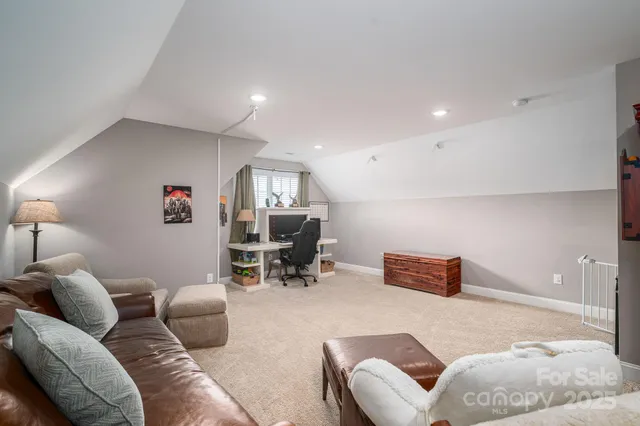 a living room with furniture and a piano