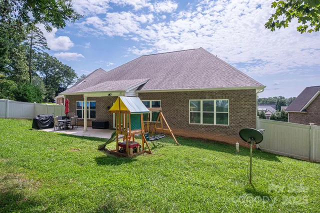 a view of a house with a backyard porch and sitting area