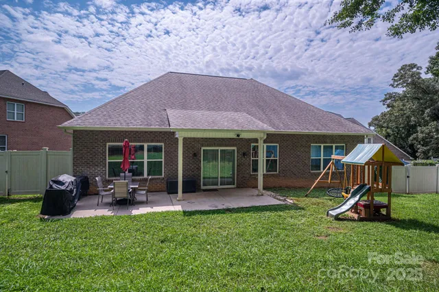 a view of a house with backyard porch and sitting area