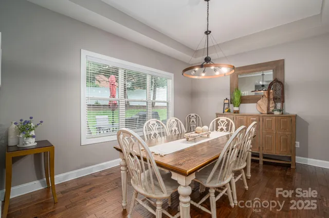 a view of a dining room with furniture wooden floor and chandelier