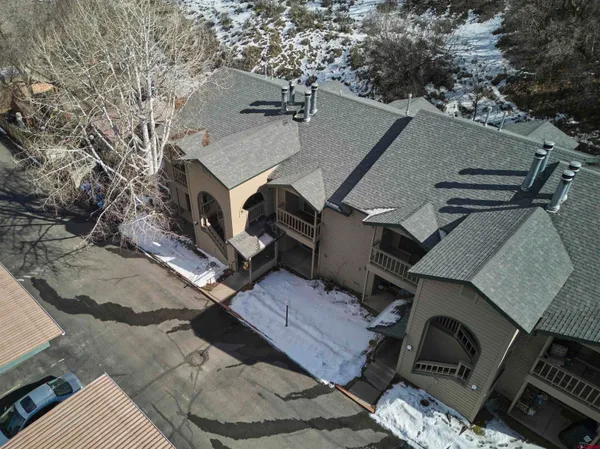 an aerial view of a house with a yard