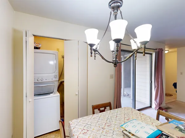 a bedroom with a bed and chandelier