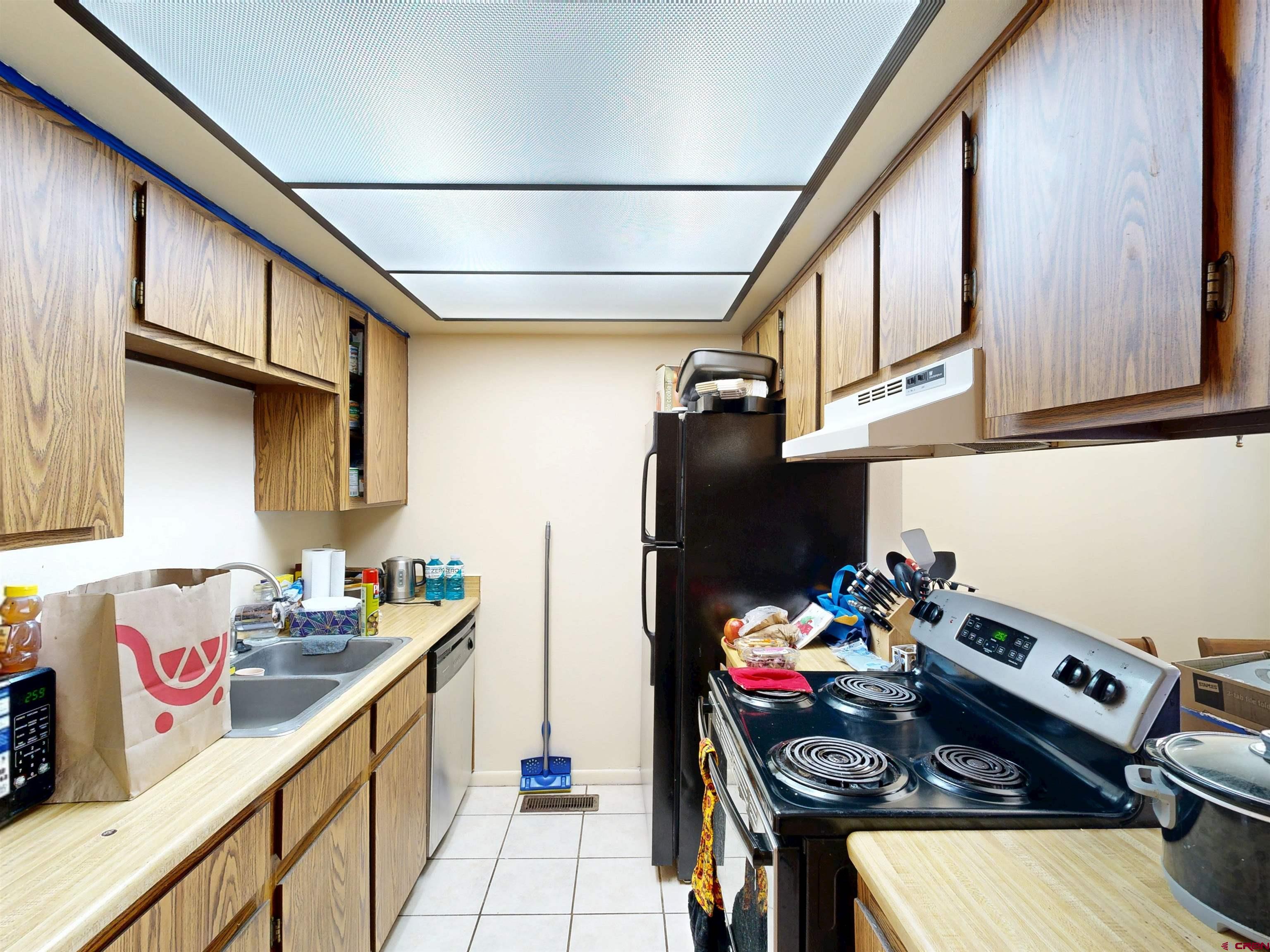 1200 Florida Road, Unit 33 Durango, CO 81301 - Photo 5 of 22 a kitchen with stainless steel appliances granite countertop a sink stove and refrigerator
