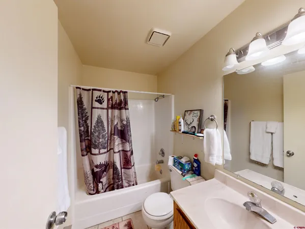 a bathroom with a sink vanity mirror and toilet