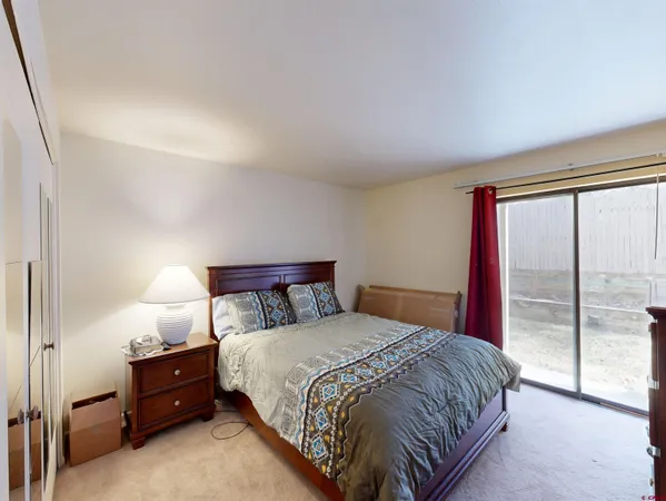 a bedroom with a bed and a night stand