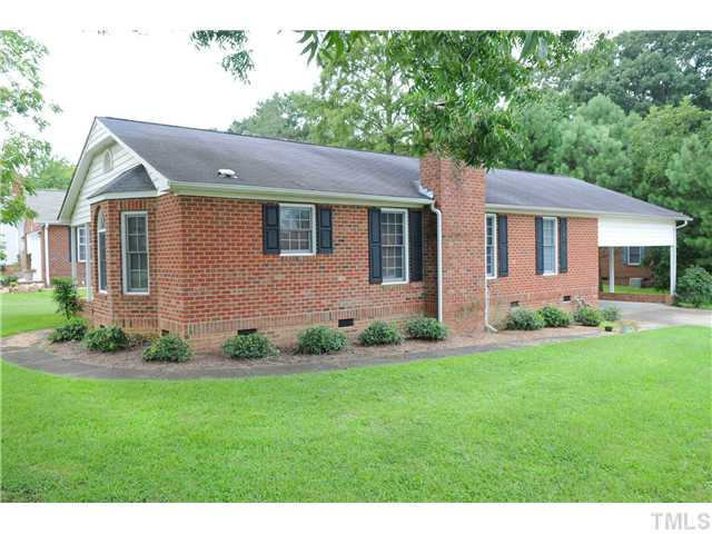 540 North O'Neil Street Clayton, NC 27520 - Photo 3 of 4 a front view of a house with a garden and yard