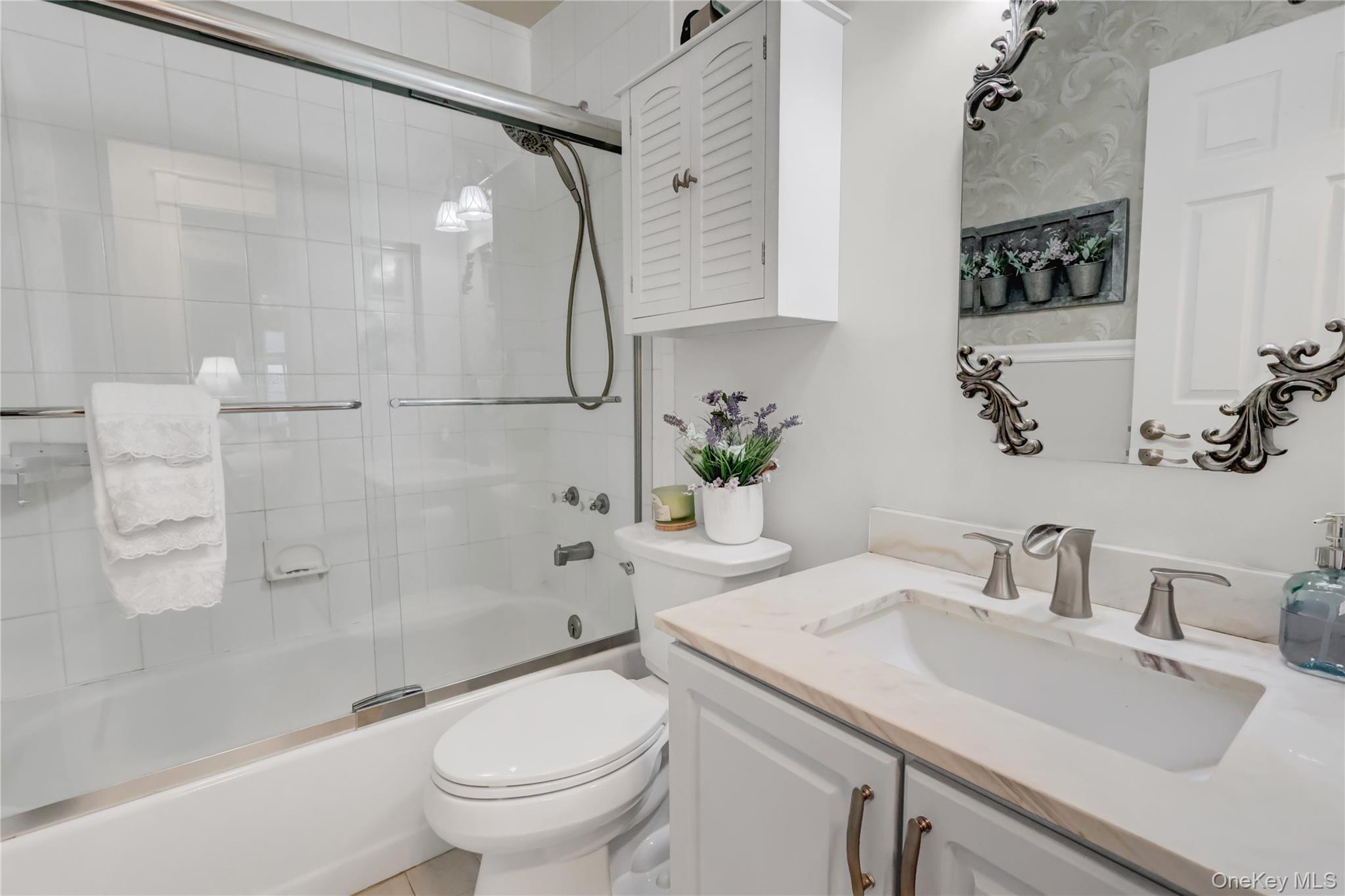 14 Chipmunk Trail Coram, NY 11727 - Photo 13 of 41 a bathroom with a sink toilet and shower