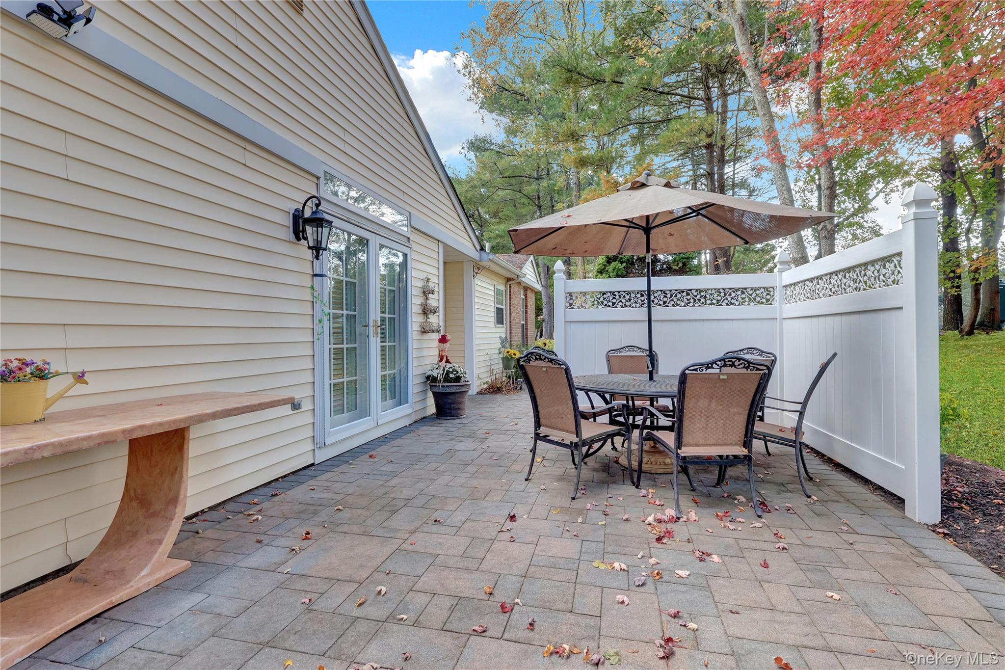 14 Chipmunk Trail Coram, NY 11727 - Photo 21 of 41 a view of a patio with table and chairs under an umbrella