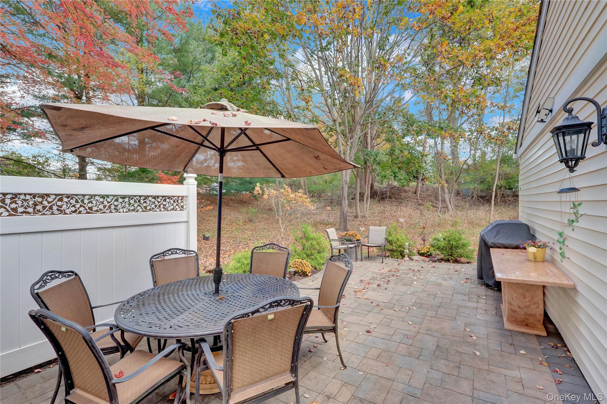 14 Chipmunk Trail Coram, NY 11727 - Photo 22 of 41 a patio with a patio table and chairs