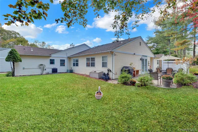 a view of a house with a backyard and a patio
