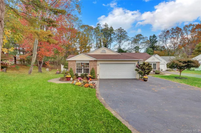 a front view of house with yard and green space