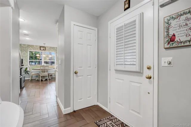 a view of dining room with furniture and front door