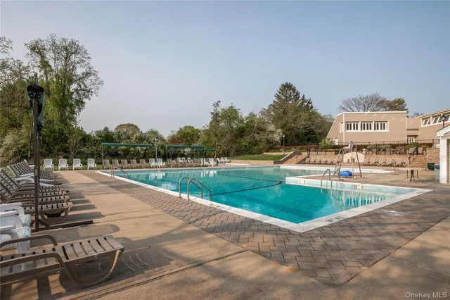 a view of a swimming pool and a yard