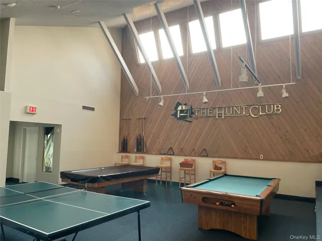 a room with pool table and window