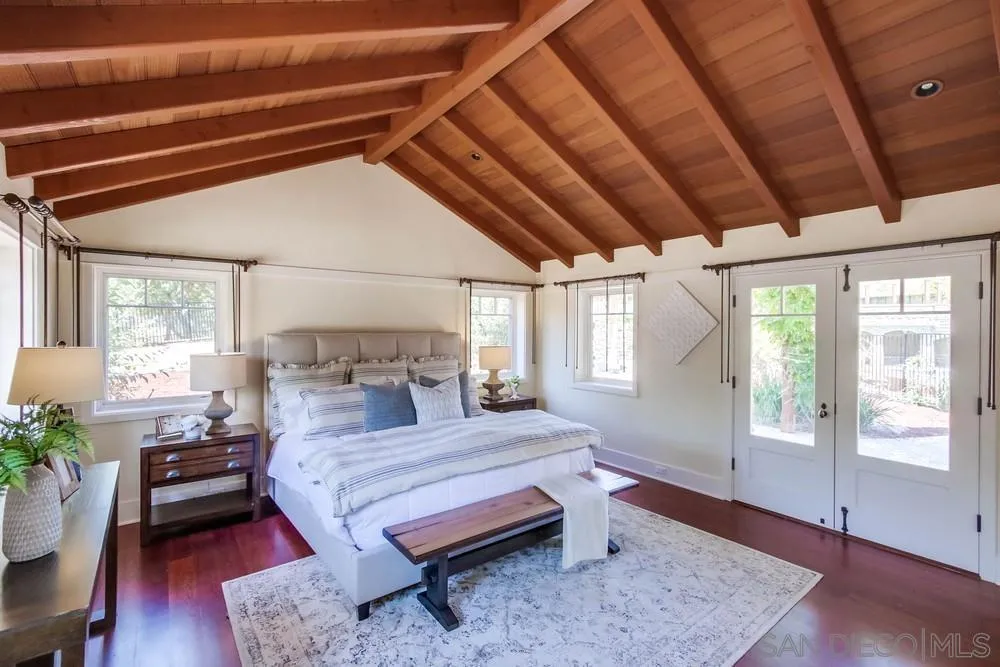13980 Millards Ranch Lane Poway, CA 92064 - Photo 18 of 75 a bedroom with a bed a table and chair with wooden floor