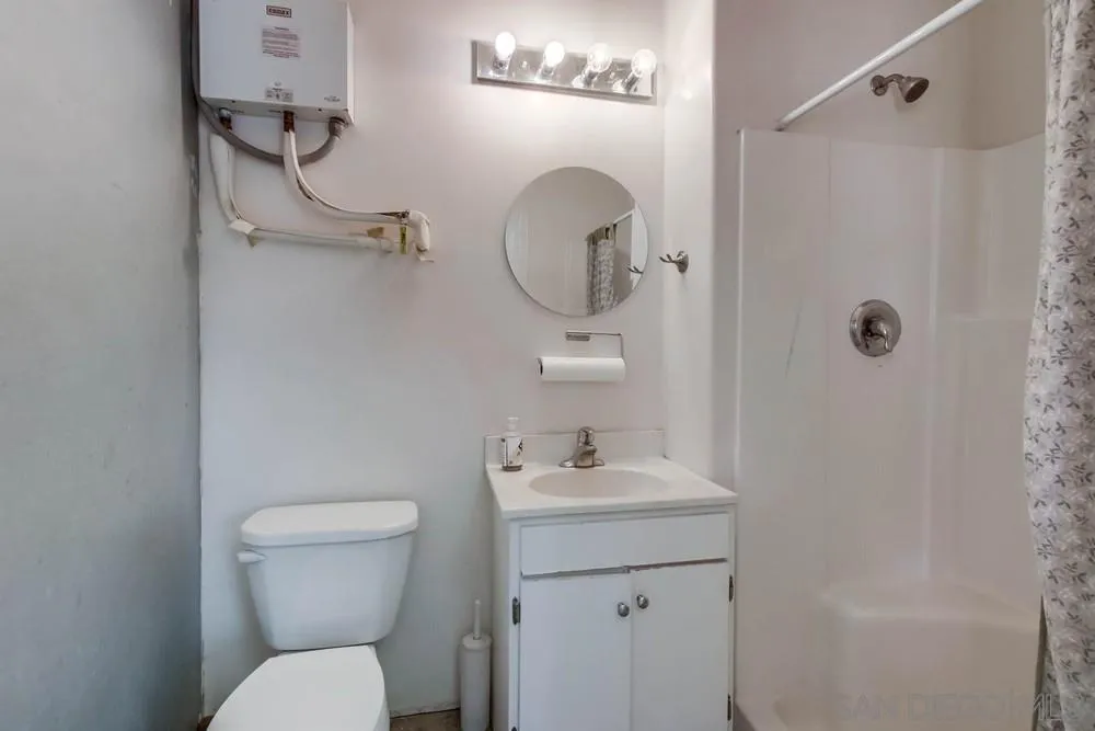 13980 Millards Ranch Lane Poway, CA 92064 - Photo 47 of 75 a bathroom with a toilet sink and mirror