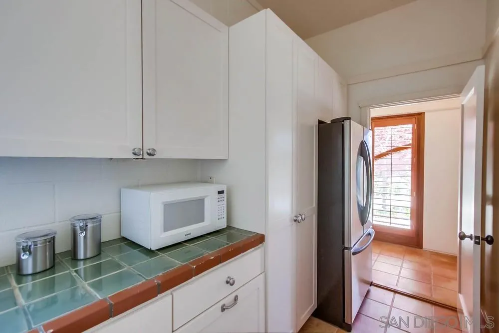 13980 Millards Ranch Lane Poway, CA 92064 - Photo 69 of 75 a kitchen with granite countertop white cabinets and white appliances