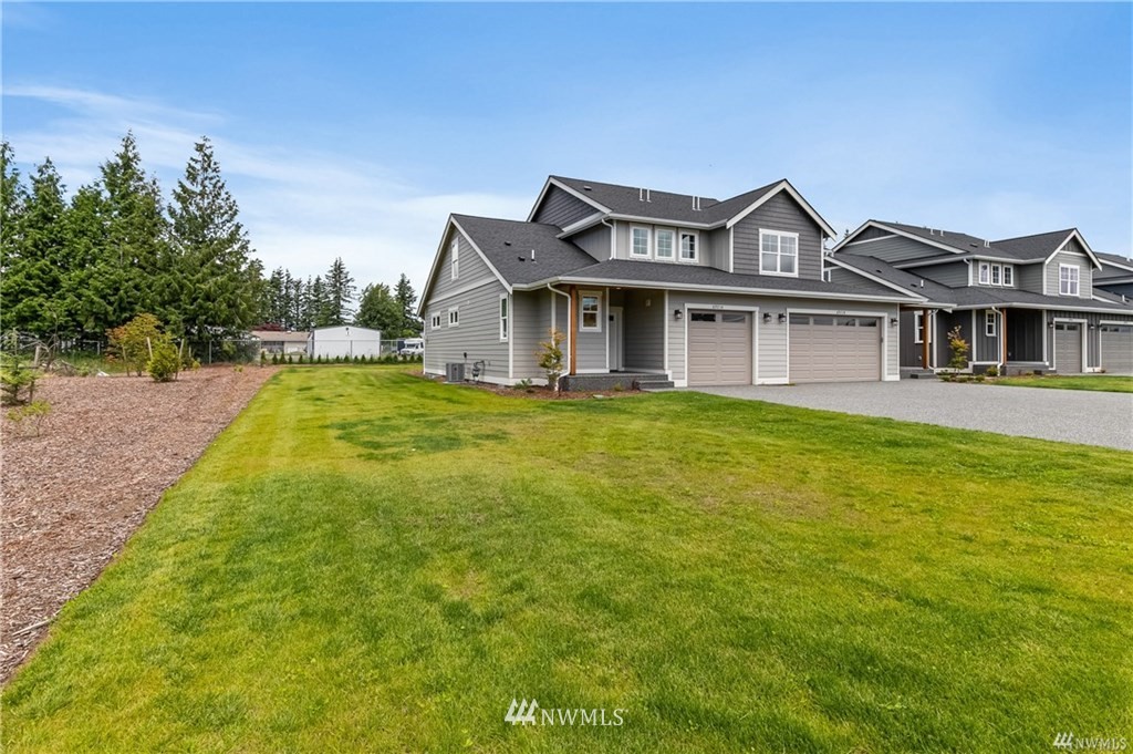 6934 Red Ridge Drive, Unit B Lynden, WA 98264 - Photo 2 of 34 a view of a house with a big yard potted plants and large tree
