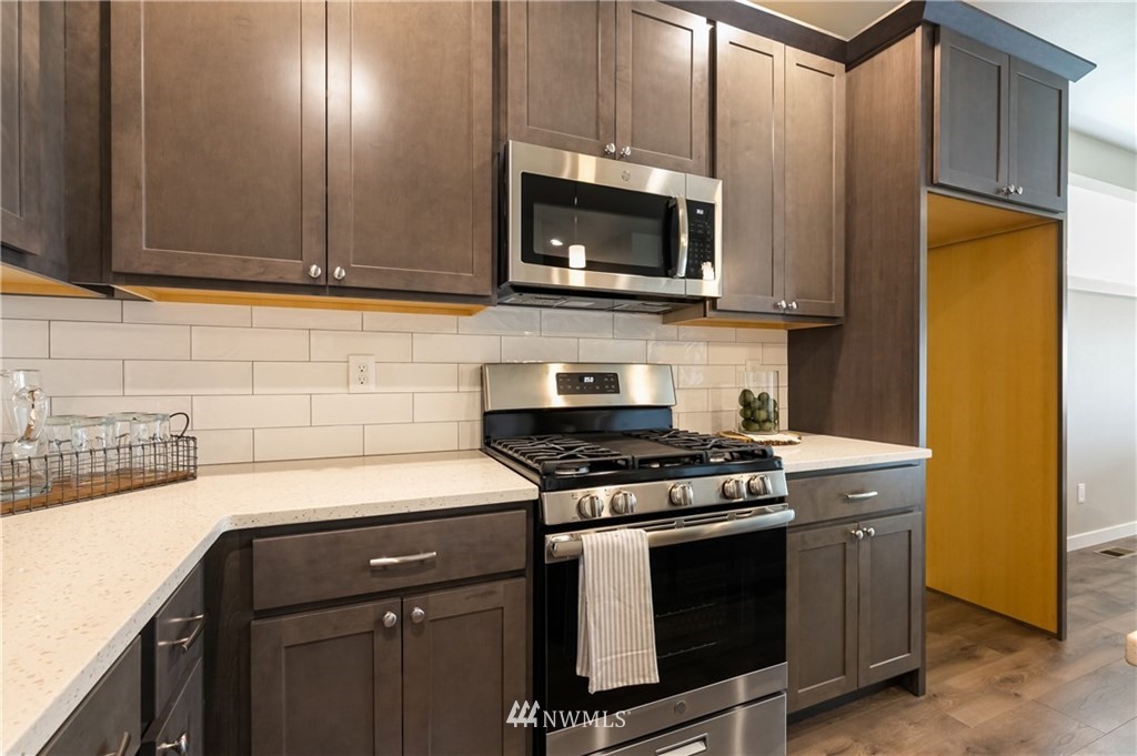 6934 Red Ridge Drive, Unit B Lynden, WA 98264 - Photo 12 of 34 a kitchen with stainless steel appliances granite countertop a stove and a microwave