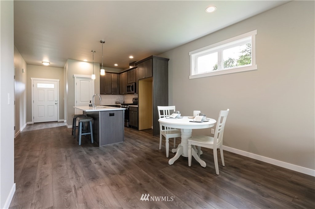 6934 Red Ridge Drive, Unit B Lynden, WA 98264 - Photo 13 of 34 a view of a dining room with furniture and wooden floor