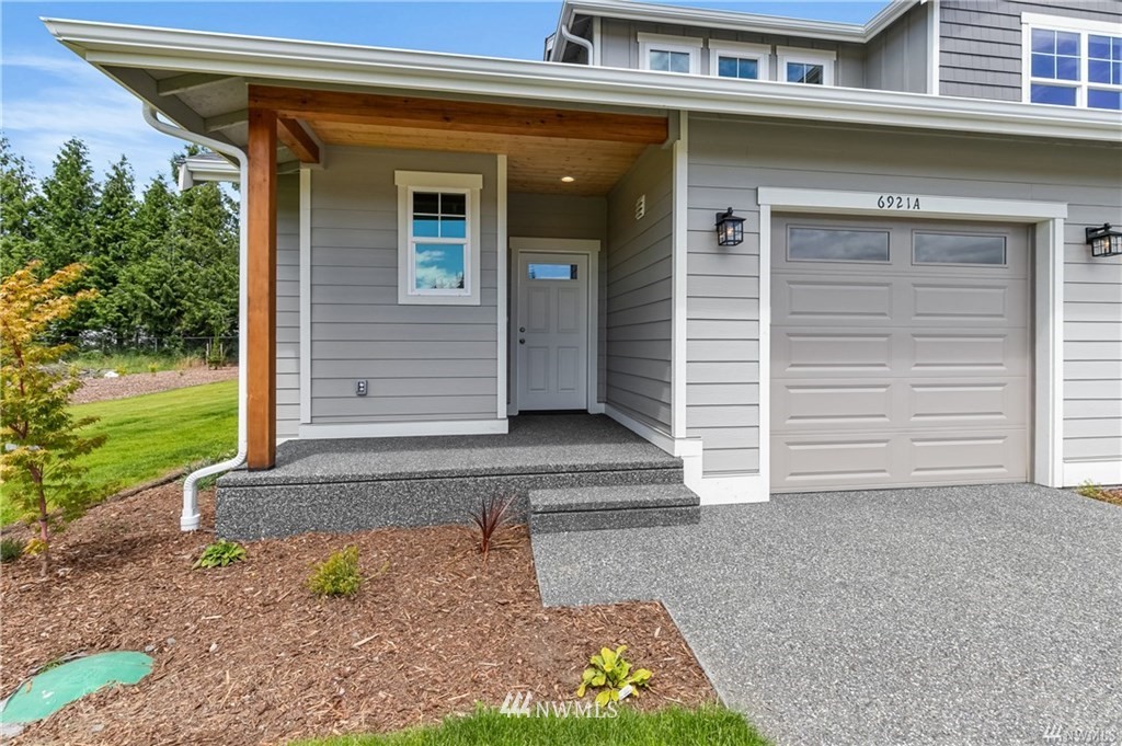 6934 Red Ridge Drive, Unit B Lynden, WA 98264 - Photo 3 of 34 a front view of a house with garden