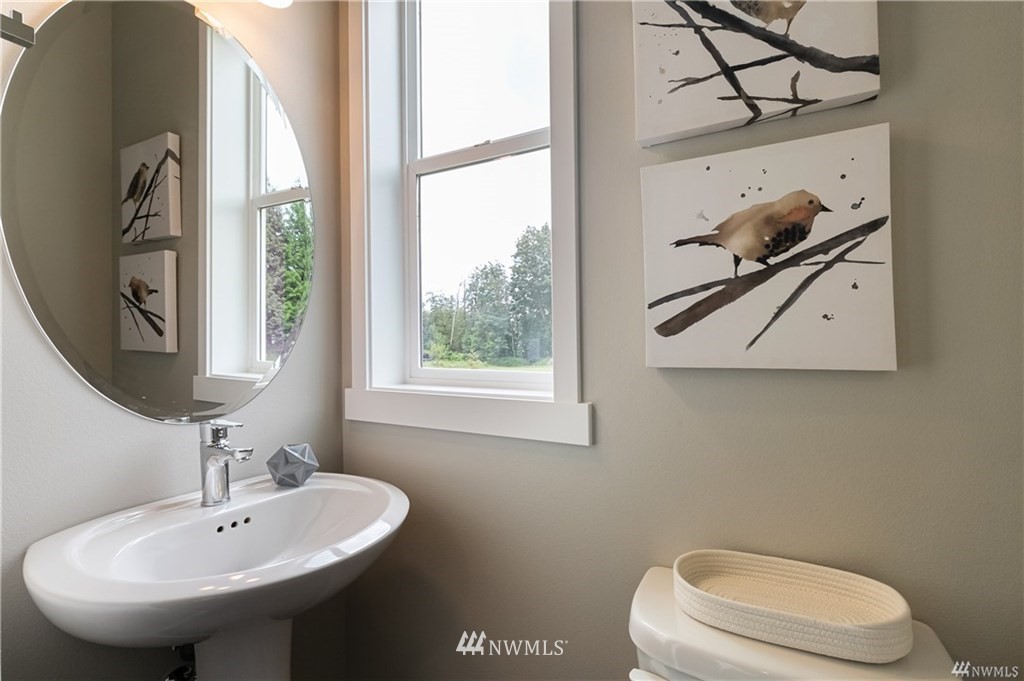 6934 Red Ridge Drive, Unit B Lynden, WA 98264 - Photo 5 of 34 a bathroom with a sink a mirror and a toilet