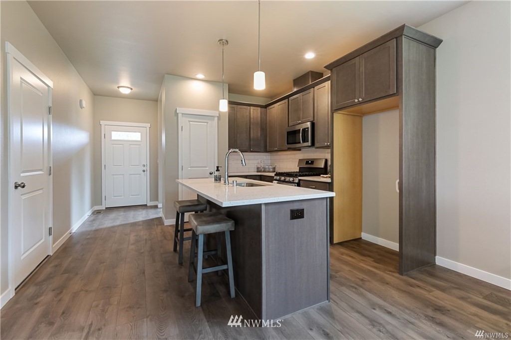 6934 Red Ridge Drive, Unit B Lynden, WA 98264 - Photo 9 of 34 a kitchen with kitchen island a sink appliances and cabinets
