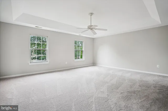 an empty room with a empty space and windows