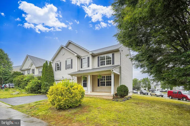 a view of an house with pool and trees