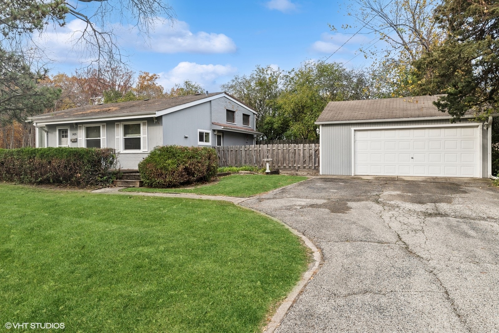 1425 Sunset Ridge Road Northbrook, IL 60062 - Photo 3 of 17 a front view of a house with a yard and garage