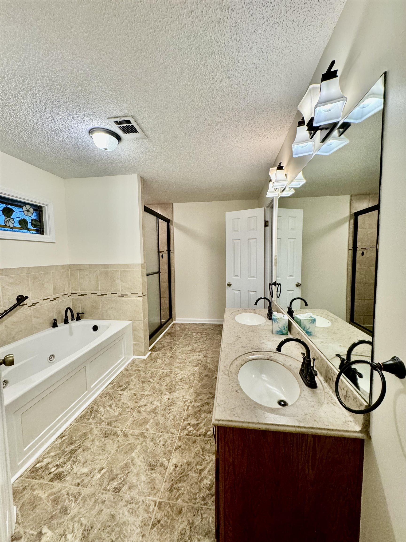 7245 Barnstable Road Memphis, TN 38125 - Photo 18 of 36 Bathroom with plus walk in shower, tile patterned floors, a textured ceiling, and vanity