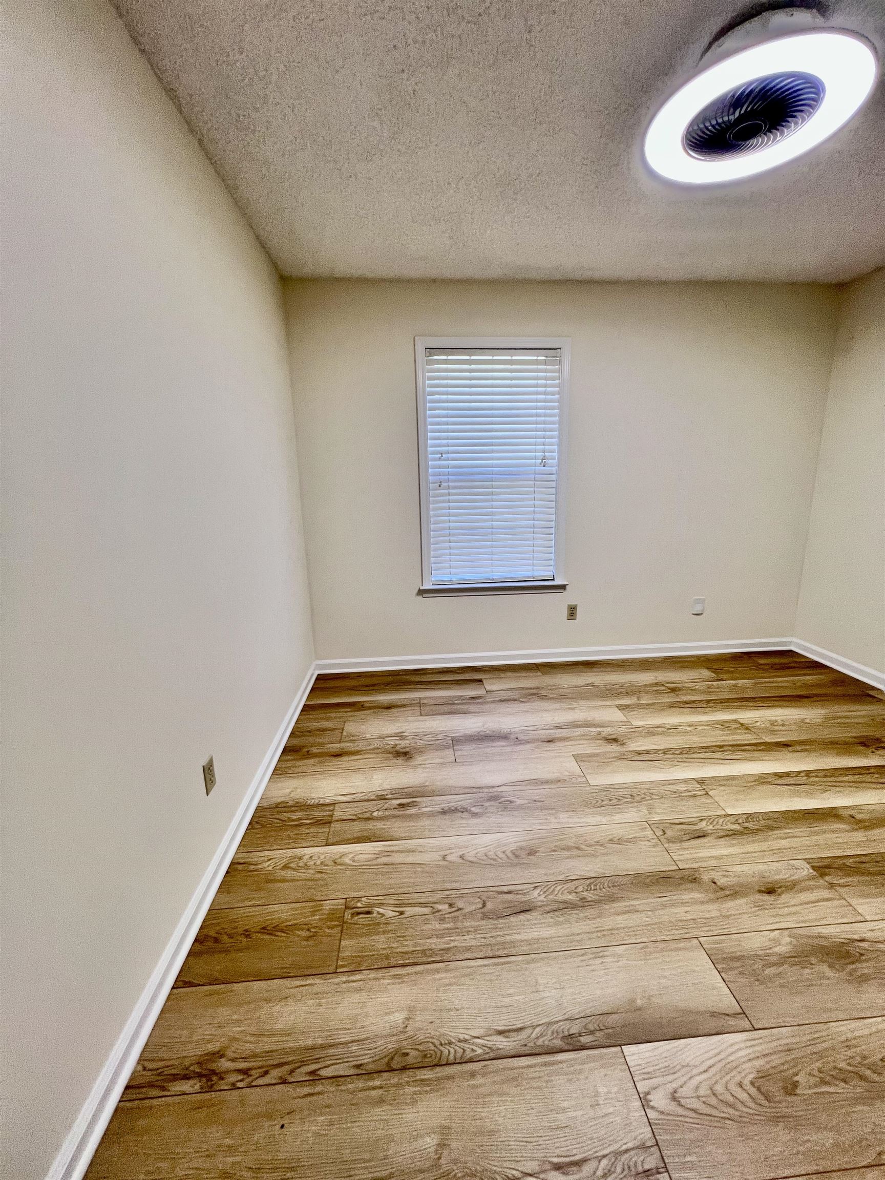 7245 Barnstable Road Memphis, TN 38125 - Photo 23 of 36 Empty room featuring a textured ceiling and hardwood / wood-style flooring