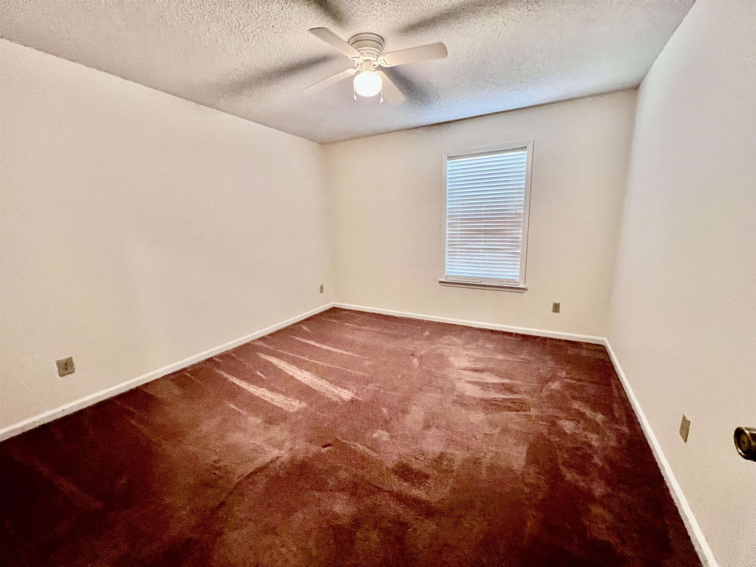 7245 Barnstable Road Memphis, TN 38125 - Photo 25 of 36 Unfurnished room with dark colored carpet, a textured ceiling, and ceiling fan