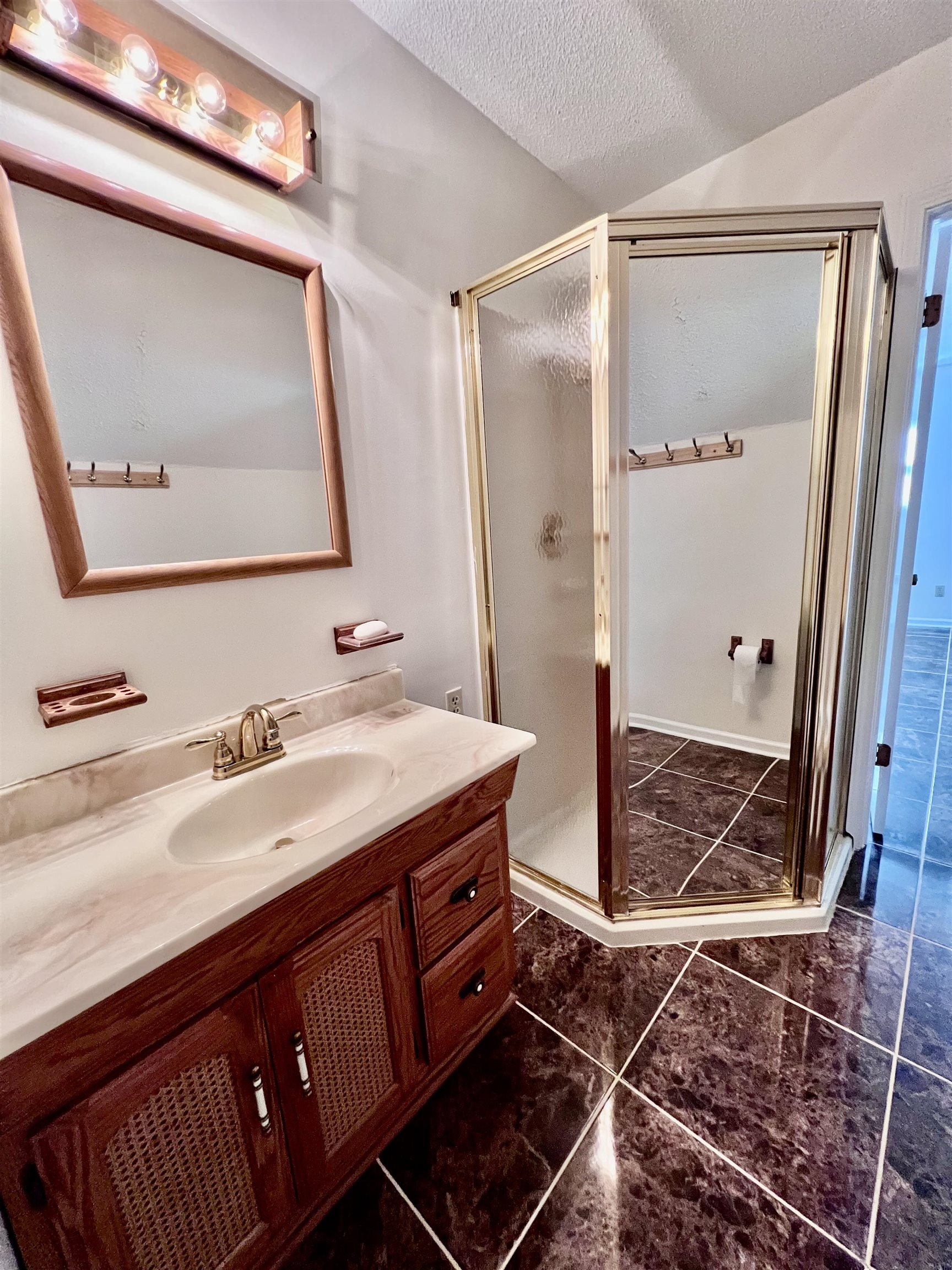 7245 Barnstable Road Memphis, TN 38125 - Photo 28 of 36 Bathroom featuring vanity, tile patterned flooring, a textured ceiling, and an enclosed shower