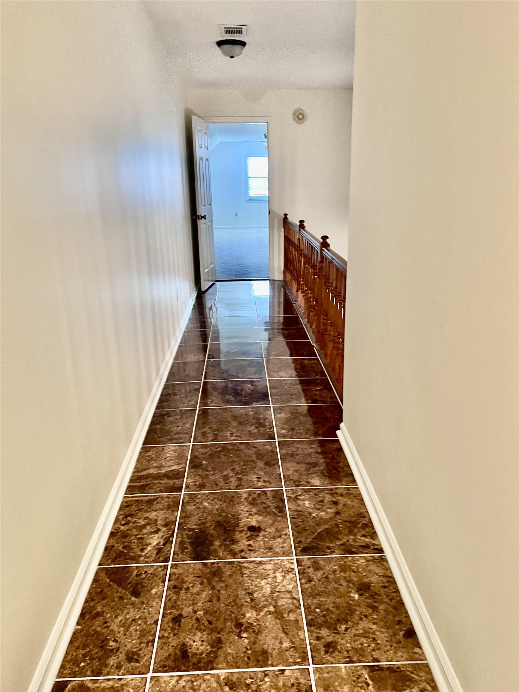 7245 Barnstable Road Memphis, TN 38125 - Photo 30 of 36 Hallway with dark tile patterned floors
