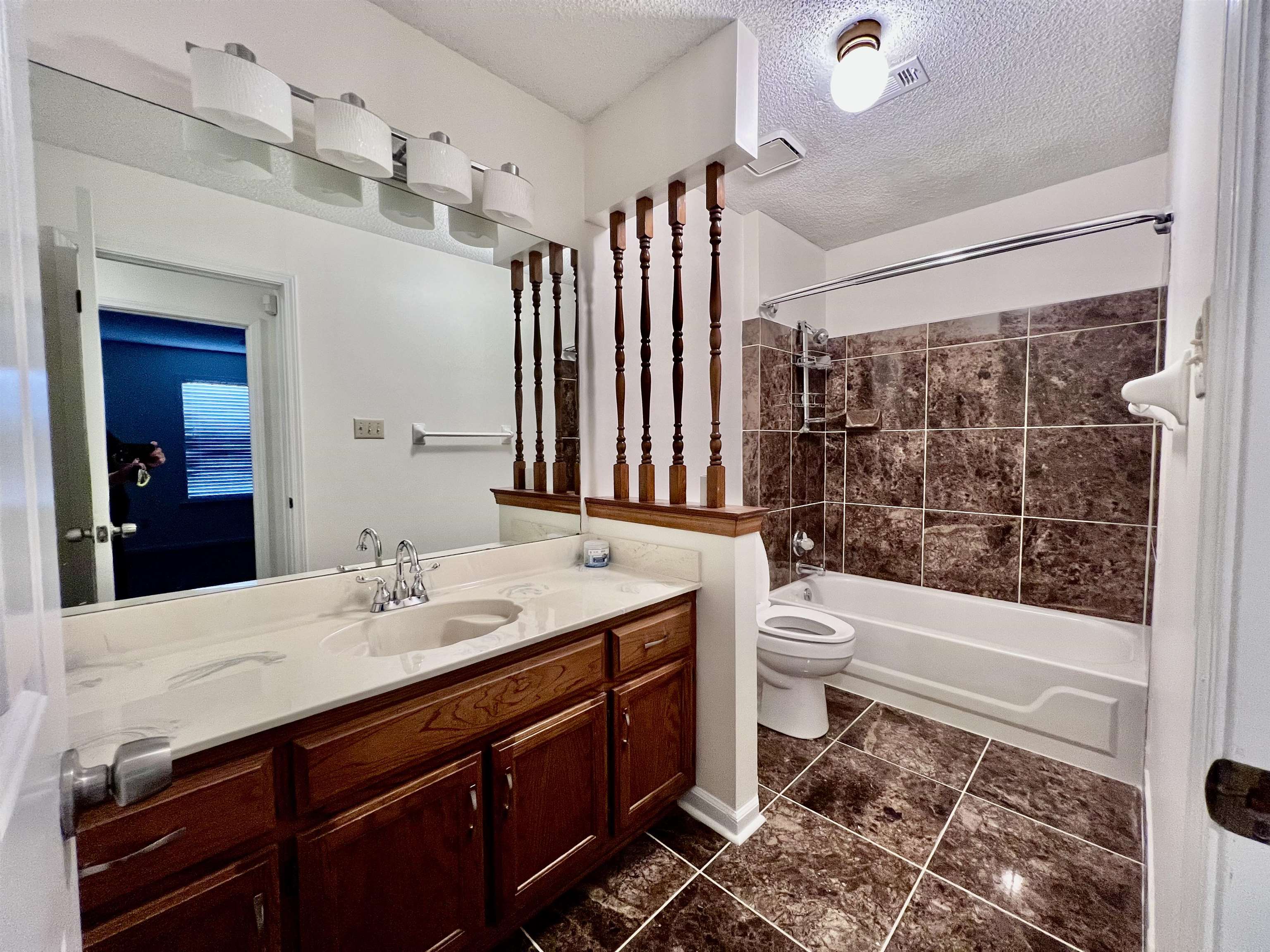 7245 Barnstable Road Memphis, TN 38125 - Photo 33 of 36 Full bathroom with toilet, tile patterned flooring, tiled shower / bath combo, vanity, and a textured ceiling