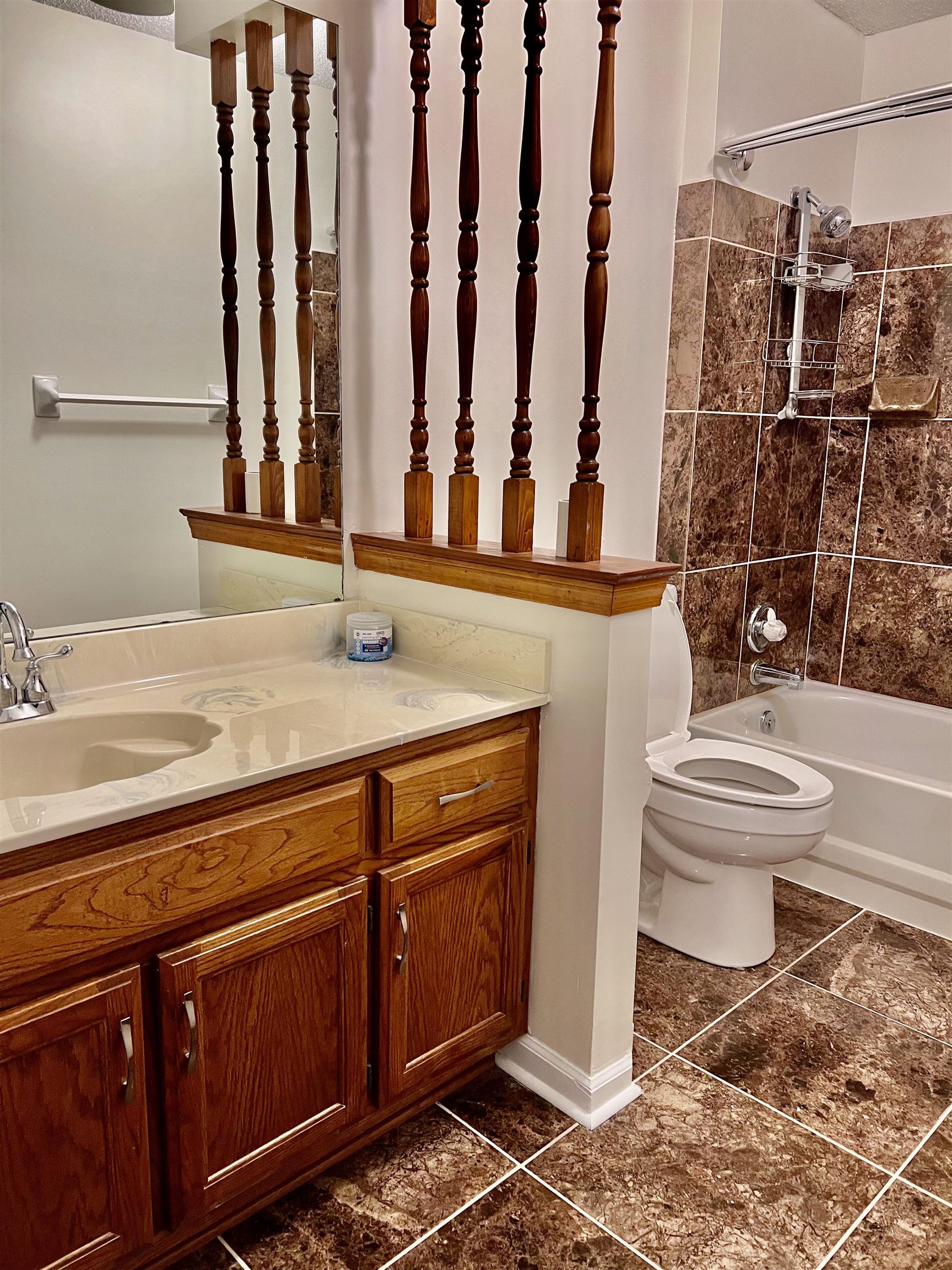 7245 Barnstable Road Memphis, TN 38125 - Photo 34 of 36 Full bathroom with vanity, toilet, tiled shower / bath combo, and tile patterned flooring