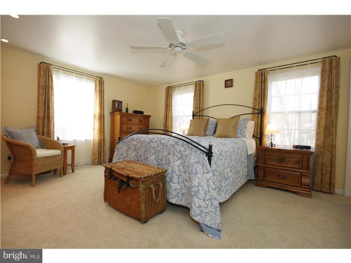 3 Kendles Run Road Moorestown, NJ 08057 - Photo 11 of 19 a spacious bedroom with a bed a couch and a window