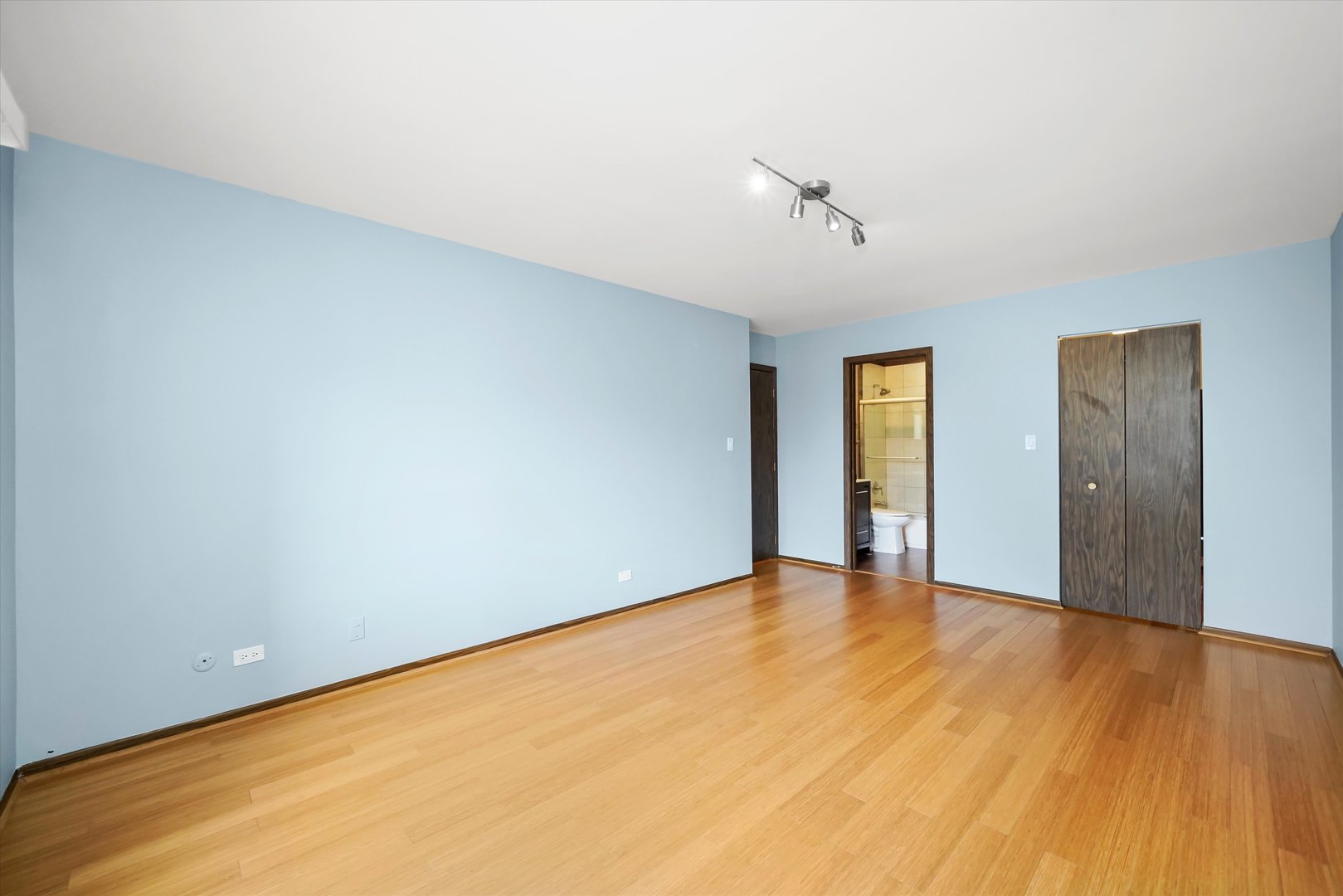 1400 North Elmhurst Road, Unit 302 Mount Prospect, IL 60056 - Photo 11 of 18 a view of an empty room with wooden floor and ceiling fan