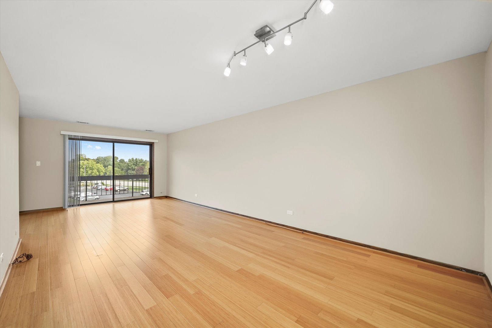 1400 North Elmhurst Road, Unit 302 Mount Prospect, IL 60056 - Photo 13 of 18 an empty room with wooden floor and windows