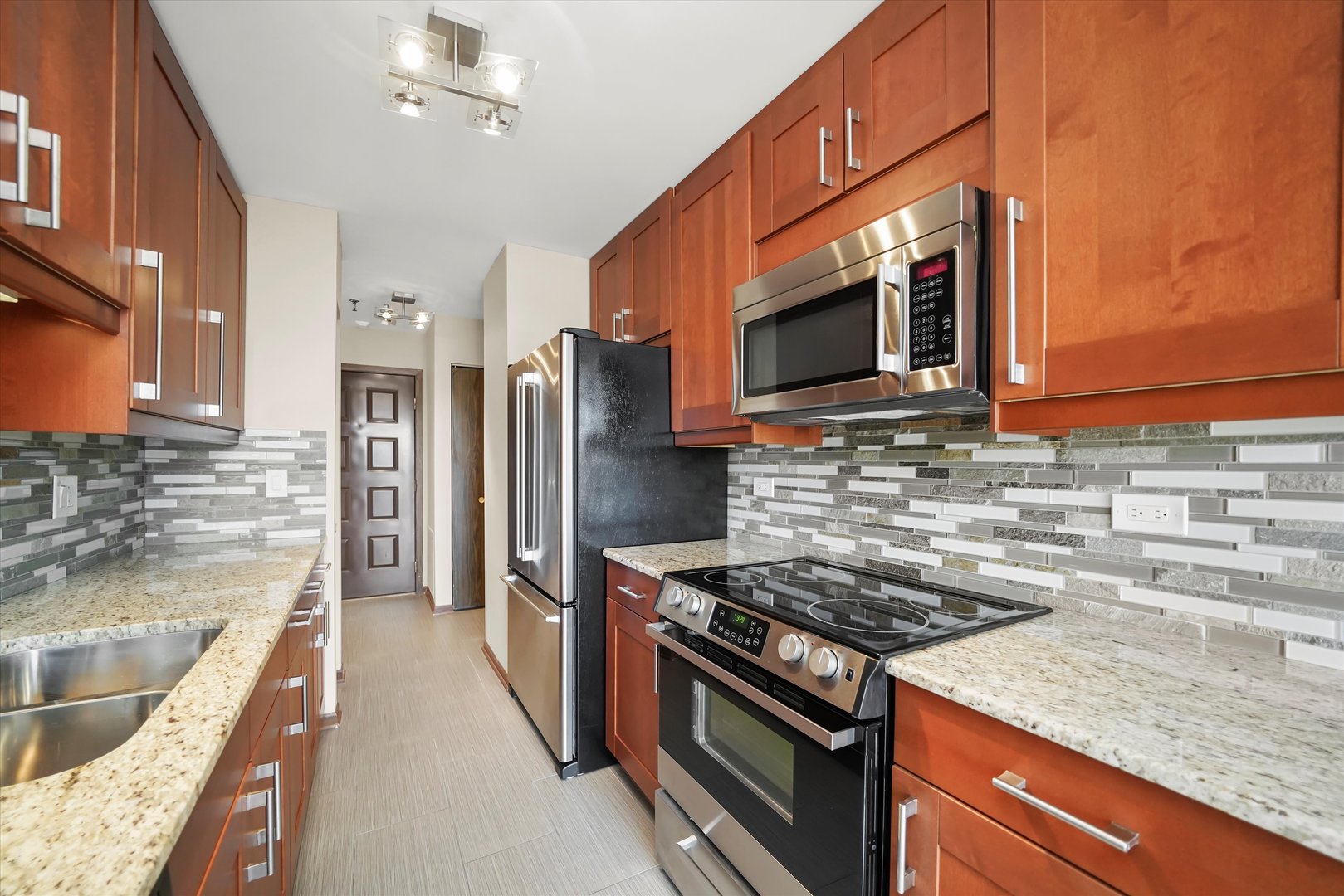 1400 North Elmhurst Road, Unit 302 Mount Prospect, IL 60056 - Photo 5 of 18 a kitchen with stainless steel appliances granite countertop a sink stove and refrigerator