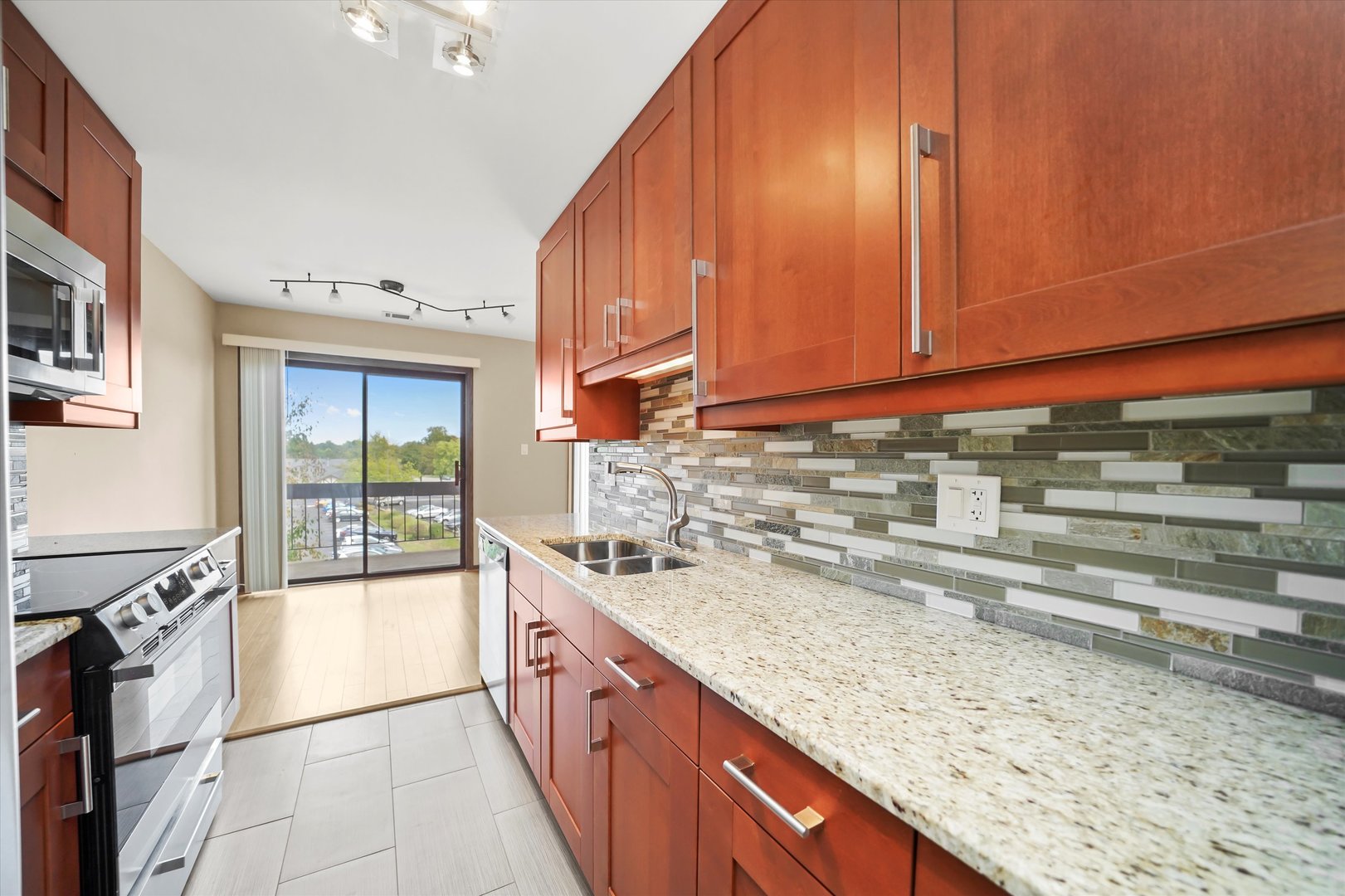 1400 North Elmhurst Road, Unit 302 Mount Prospect, IL 60056 - Photo 6 of 18 a kitchen with a sink and a stove
