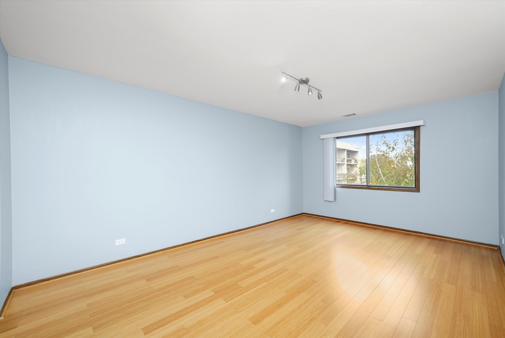 1400 North Elmhurst Road, Unit 302 Mount Prospect, IL 60056 - Photo 10 of 18 wooden floor in an empty room with a window