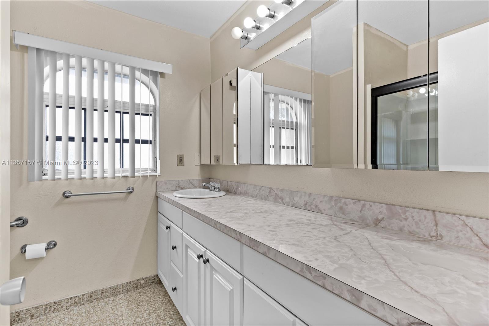 West Perrine Miami, FL 33157 - Photo 13 of 23 a bathroom with a granite countertop sink a large mirror and a shower