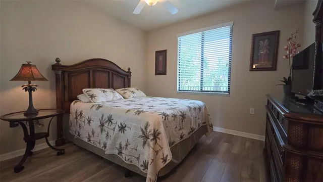 a bedroom with a bed and a flat tv screen on a dresser