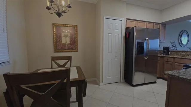 a kitchen with a refrigerator and cabinets