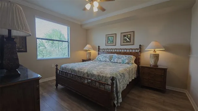 a bedroom with a bed and a flat tv screen on a dresser