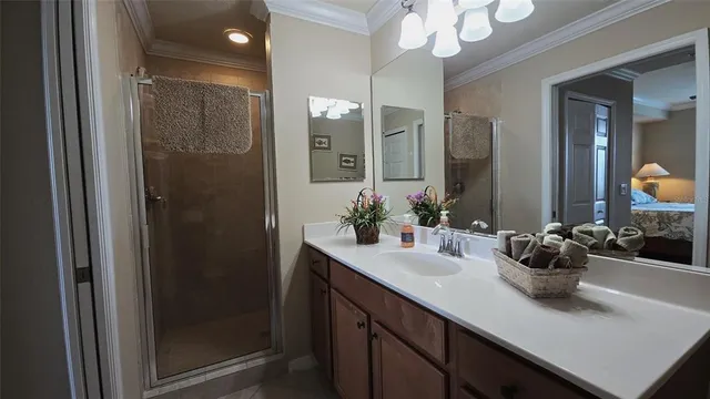 a bathroom with a sink a potted plant and a mirror