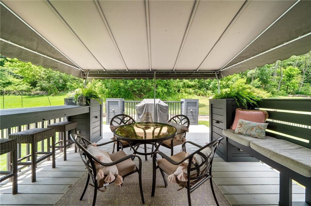 230 McWilliams Road Trafford, PA 15085 - Photo 29 of 50 Custom deck with bar, bench seating, built in flower boxes and lighting. Freshly painted summer 2023. Gas grill with gas line so you never run out of fuel!