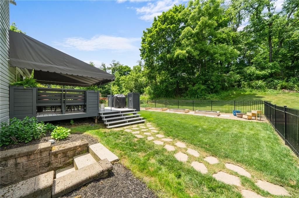 230 McWilliams Road Trafford, PA 15085 - Photo 47 of 50 Backyard view - canopy covers deck for all weather entertaining. Steps lead to lower level walk up.